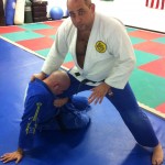 Victor is standing and Robert has grabbed control of Victor's right leg.