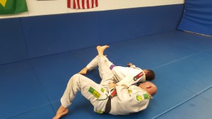 Robert uses his hook and grip on Morrow's belt to throw Morrow to the side.