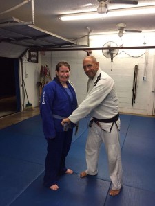 Megan receives her blue belt in Gracie Jiu-Jitsu from Master Victor Huber.